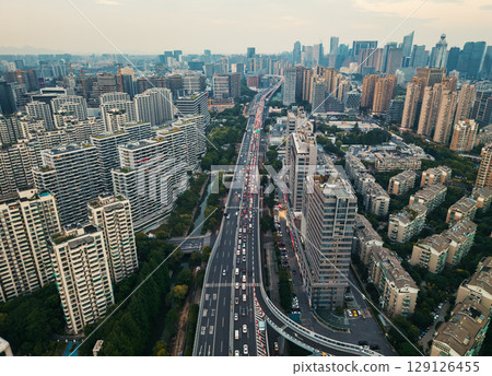 Aerial view of a busy highway surrounded by urban skyscrapers during sunset in a major city Aerial view of a busy highway surrounded by urban skyscrapers during sunset in a major city 129126455
