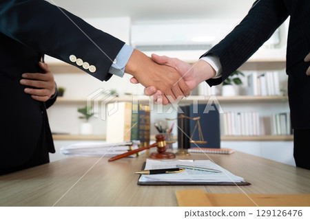 Successful Negotiation. Professionals shaking hands after finalizing a legal agreement. Successful Negotiation. Professionals shaking hands after finalizing a legal agreement. 129126476