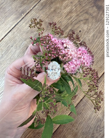 Elegant oval ring on wooden table 129127301