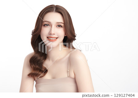 A beautiful young Asian woman with clean, fresh skin against a white background. Skincare, facial treatment, cosmetology, beauty, and spa. An elegant portrait of an Asian woman. 129127404