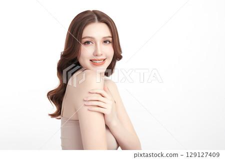 A beautiful young Asian woman with clean, fresh skin against a white background. Skincare, facial treatment, cosmetology, beauty, and spa. An elegant portrait of an Asian woman. 129127409