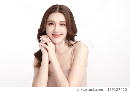A beautiful young Asian woman with clean, fresh skin against a white background. Skincare, facial treatment, cosmetology, beauty, and spa. An elegant portrait of an Asian woman. A beautiful young Asian woman with clean, fresh skin against a white background. Skincare, facial treatment, cosmetology, beauty, and spa. An elegant portrait of an Asian woman. 129127420