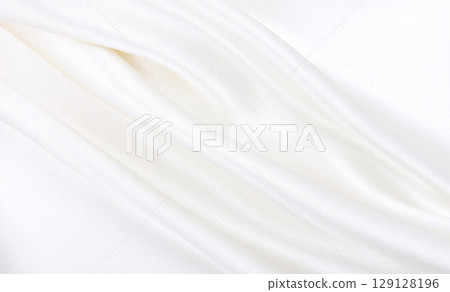 Smooth elegant white silk or satin luxury cloth texture as wedding background. Luxurious background design 129128196