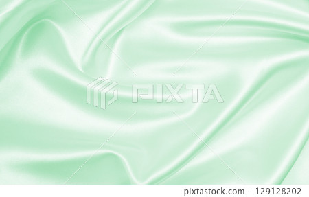 Smooth elegant green silk or satin luxury cloth texture as abstract background. Luxurious background design Smooth elegant green silk or satin luxury cloth texture as abstract background. Luxurious background design 129128202