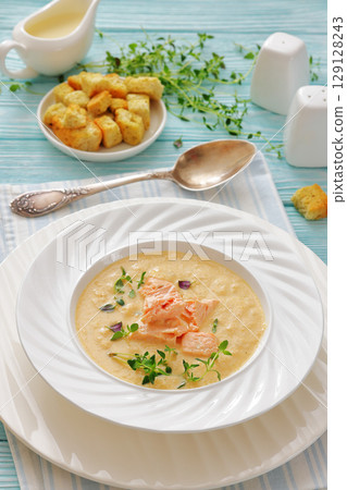 creamy salmon soup with herb in a bowl 129128243