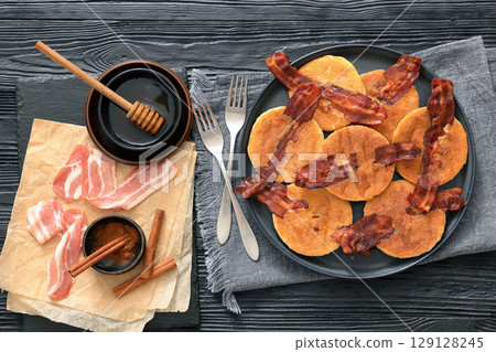 bacon pancakes drizzled with sirup on a plate bacon pancakes drizzled with sirup on a plate 129128245