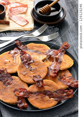 bacon pancakes drizzled with sirup on a plate bacon pancakes drizzled with sirup on a plate 129128246