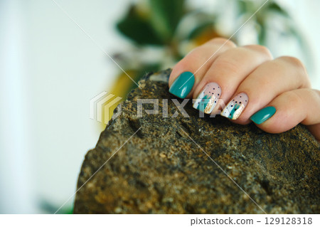 Female hands with green nail design. Female hands with green nail design. 129128318