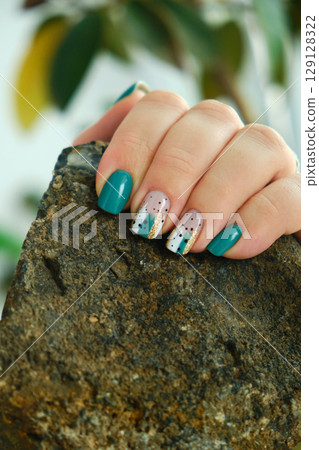 Female hands with green nail design. Female hands with green nail design. 129128322