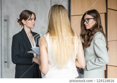 Female coworkers discussing a work project 129128616