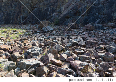 Rocky background forming an arid landscape at the foot of a mountain Rocky background forming an arid landscape at the foot of a mountain 129129114