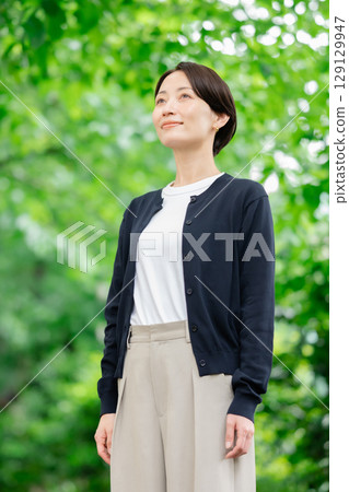 A woman standing in fresh green 129129947