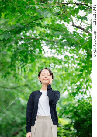 A woman standing in fresh green A woman standing in fresh green 129129948