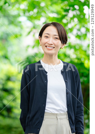A woman standing in fresh green A woman standing in fresh green 129129949