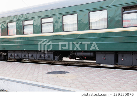 Detailed view of train undercarriage showcasing suspension system and wheel assembly at a railway station Detailed view of train undercarriage showcasing suspension system and wheel assembly at a railway station 129130076