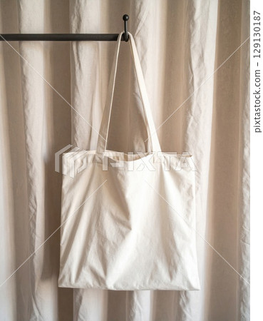 Hanging Plain Cotton Canvas Tote Bag With Beige Fabric Background and Minimalist Style 129130187