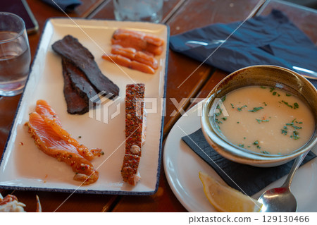 Traditional Norwegian whale meat, salmon slices, and creamy fish soup served at local restaurant Traditional Norwegian whale meat, salmon slices, and creamy fish soup served at local restaurant 129130466