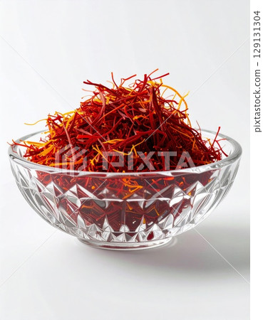 Closeup of Saffron Threads in Crystal Bowl Against White Background Still Life 129131304