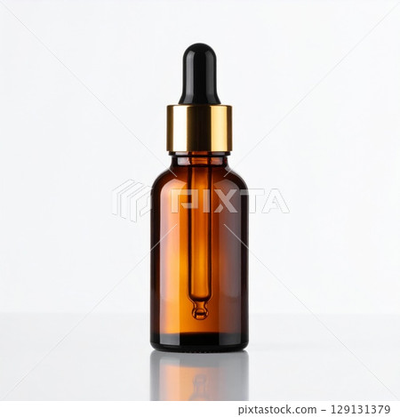 Amber Glass Serum Bottle with Golden Dropper on White Reflective Surface Amber Glass Serum Bottle with Golden Dropper on White Reflective Surface 129131379
