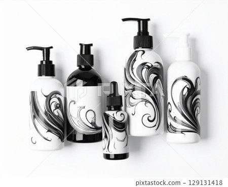 Assorted Black and White Cosmetic Bottles with Abstract Floral Designs on White Background 129131418