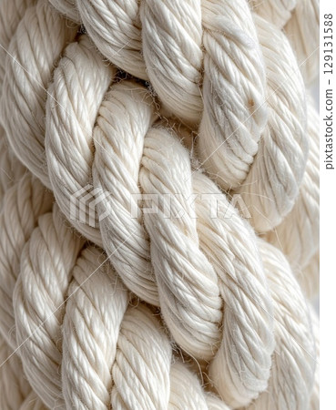 Close Up of Intertwined Braided White Rope with Detailed Texture on Bright Background 129131588
