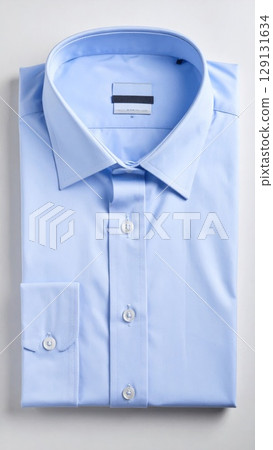 Folded Light Blue Long Sleeve Dress Shirt on a White Background in Studio Lighting 129131634