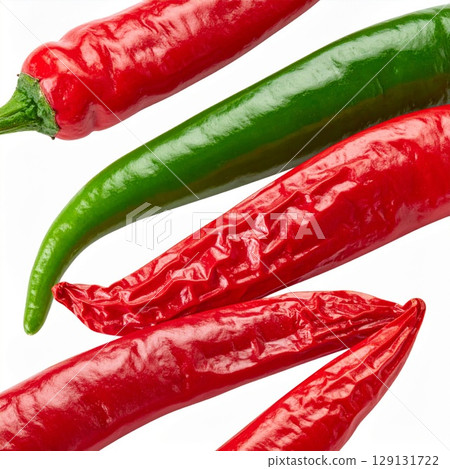 Close Up of Vibrant Red and Green Chili Peppers on a White Background 129131722