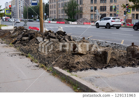 Urban Construction Area Featuring Challenging Uneven Ground and Ongoing Excavation Work Urban Construction Area Featuring Challenging Uneven Ground and Ongoing Excavation Work 129131963