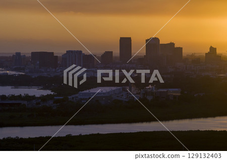 Aerial view of downtown district of Tampa city in Florida, USA at sunset. Dark silhouette of high skyscraper office buildings in modern american midtown Aerial view of downtown district of Tampa city in Florida, USA at sunset. Dark silhouette of high skyscraper office buildings in modern american midtown 129132403