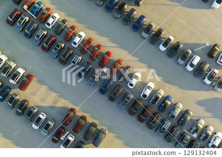 Aerial view of dealership parking lot with many brand new cars for sale. Development of american automotive industry concept Aerial view of dealership parking lot with many brand new cars for sale. Development of american automotive industry concept 129132404