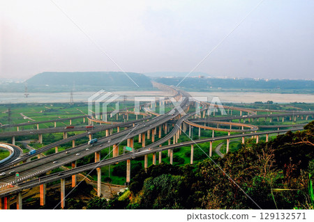 Zhongqing Interchange at dusk in Taichung, Taiwan, with traffic flowing. 129132571