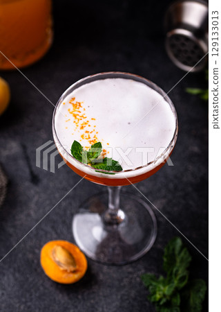 Fresh apricot cocktail martini with mint 129133013