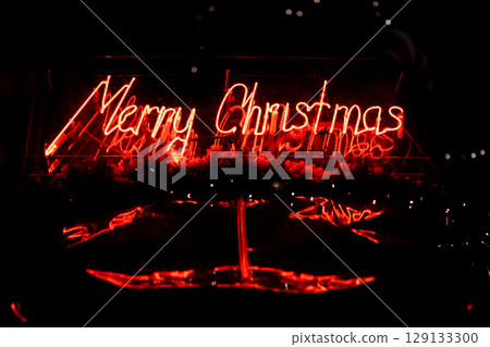 led red Christmas decoration and ornaments over abstract bokeh background with copy space. Holiday background greeting card for Christmas and New Year. Merry Christmas 129133300