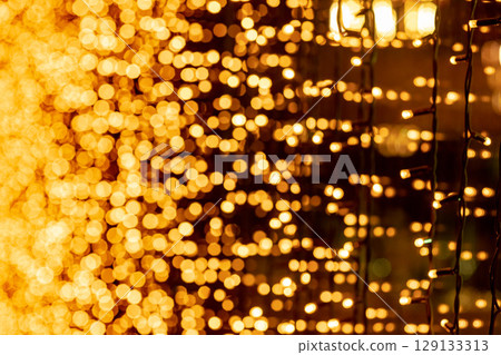 Abstract circular bokeh background of Christmaslight. bokeh from garlands. background for screensaver. Defocused lights. Blurred bokeh with yellow color lights. Abstract circular bokeh background of Christmaslight. bokeh from garlands. background for screensaver. Defocused lights. Blurred bokeh with yellow color lights. 129133313