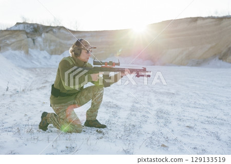 Soldier training with rifle in winter shooting range Soldier training with rifle in winter shooting range 129133519
