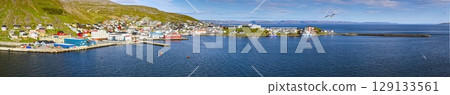 Fishing port Honningsvag Nordkapp with boats and colourful village 129133561