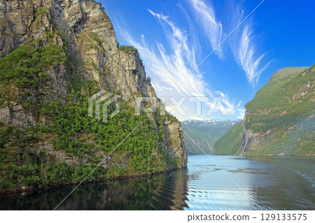 steep cliff waterfall view over geirangerfjord from ship 129133575
