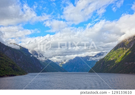 geirangerfjord wide fjord valley vista under cloudy sky geirangerfjord wide fjord valley vista under cloudy sky 129133610