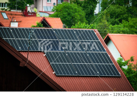 House roof with photovoltaic modules. Historic farm house with modern solar panels on roof and wall High quality photo House roof with photovoltaic modules. Historic farm house with modern solar panels on roof and wall High quality photo 129134228