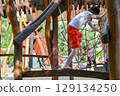 life of children in a modern city - little boy is having fun on the playground near the house. High quality photo 129134250