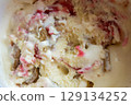 Close up of white and red ice cream, ice cream with strawberries jam and chocolate, macro, closeup. High quality photo 129134252