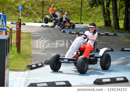 Girl driving quad bike, four wheel cycle car, spring brightly morning, sunny day. High quality photo Girl driving quad bike, four wheel cycle car, spring brightly morning, sunny day. High quality photo 129134253