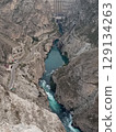 Aerial view of Chirkeyskaya HPP, Sulak Canyon hydroelectric power station, Dubki village, Dagestan, Russia, a powerful stream of turquoise water 129134263