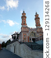 Sunni Mukhtarov Mosque in Vladikavkaz - elegant early 20th century Islamic architecture with minaret against Caucasus mountains 129134268