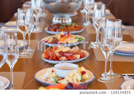 An Elegant Dining Table Setting adorned with Exquisite Gourmet Cuisine and Fine Delicacies 129134855