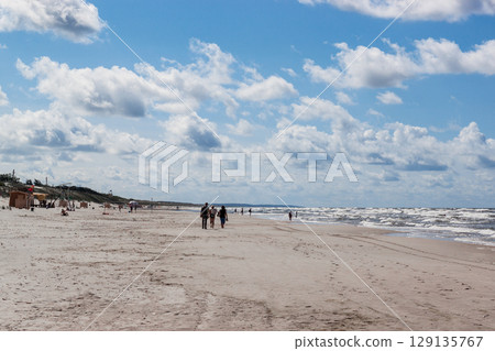 Curonian spit on a sunny summer day. Scenic view of the beach on the Baltic Sea coast in the village of Nida, Lithuania. Gray sand dunes 129135767