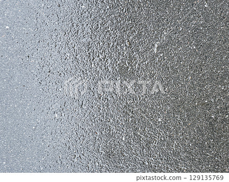 Wet asphalt background. Pavement after rain texture. 129135769
