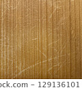 Wood surface with vertical grain and scratches 129136101