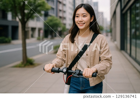 A woman riding an electric scooter around town A woman riding an electric scooter around town 129136741