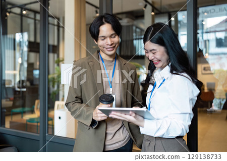 Professional Business Meeting in Modern Office with Diverse Team Collaborating and Discussing Strategies for Success 129138733